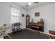 Inviting music room with an upright piano, vintage clocks, and cozy seating at 7454 Gathering Dr, Reunion, FL 34747