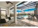 Covered patio area with lounge seating, an enclosed pool, and dining space at 7454 Gathering Dr, Reunion, FL 34747