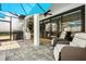 Outdoor patio with grill and lounge chairs, with access to interior living area through sliding doors at 7454 Gathering Dr, Reunion, FL 34747