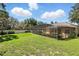 Spacious backyard featuring a screened-in lanai perfect for outdoor entertaining and enjoying the Florida weather at 7819 Canyon Lake Cir, Orlando, FL 32835