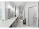 Bathroom featuring double sinks, marble floors, modern fixtures, cabinet storage and a doorway to bedroom at 7819 Canyon Lake Cir, Orlando, FL 32835