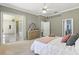 Cozy bedroom features neutral walls, carpet, ensuite and a glass sliding door to outdoor living area at 7819 Canyon Lake Cir, Orlando, FL 32835