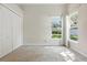 Empty bedroom features neutral walls and carpet, a double-door closet, and a bright window at 7819 Canyon Lake Cir, Orlando, FL 32835