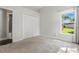 Bright bedroom with a large window, neutral carpet, and closet at 7819 Canyon Lake Cir, Orlando, FL 32835