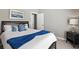 Comfortable bedroom featuring a stylish bed with decorative pillows and a modern nightstand with a lamp at 7819 Canyon Lake Cir, Orlando, FL 32835