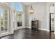 Elegant dining area featuring a large arched window, hardwood floors, and a modern light fixture at 7819 Canyon Lake Cir, Orlando, FL 32835
