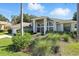 Inviting single-story home showcasing arched windows, mature landscaping, and an attached two-car garage at 7819 Canyon Lake Cir, Orlando, FL 32835