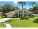 Charming single-story home featuring manicured landscaping, neutral paint, and an attached two-car garage at 7819 Canyon Lake Cir, Orlando, FL 32835
