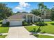 Charming single-story home featuring manicured landscaping, neutral paint, and an attached two-car garage at 7819 Canyon Lake Cir, Orlando, FL 32835