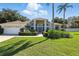 Inviting single-story home showcasing arched windows, manicured landscaping, and an attached two-car garage at 7819 Canyon Lake Cir, Orlando, FL 32835