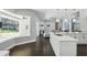 Open floorplan view of kitchen and living room with access to a screened outdoor pool at 7819 Canyon Lake Cir, Orlando, FL 32835