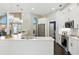 A bright kitchen with a breakfast bar, stainless appliances, and modern pendant lighting at 7819 Canyon Lake Cir, Orlando, FL 32835