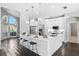 Bright open kitchen features a breakfast bar, stainless steel appliances, and elegant pendant lighting at 7819 Canyon Lake Cir, Orlando, FL 32835