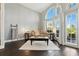 Bright living room with modern décor featuring large arched windows, high ceilings and hardwood floors at 7819 Canyon Lake Cir, Orlando, FL 32835
