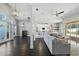 Open floor plan features hardwood floors and views into the kitchen, dining area, and pool at 7819 Canyon Lake Cir, Orlando, FL 32835