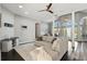 Bright living room with hardwood floors, ceiling fan, and large windows overlooking the manicured yard at 7819 Canyon Lake Cir, Orlando, FL 32835