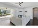 Open living space with a modern kitchen, providing seamless flow to the lanai and a beautiful pool view at 7819 Canyon Lake Cir, Orlando, FL 32835