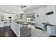 Open living space with a modern kitchen, providing seamless flow to the lanai and a beautiful pool view at 7819 Canyon Lake Cir, Orlando, FL 32835