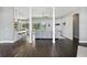 Open concept living area featuring wood flooring, a seamless flow to the kitchen, and sliding glass doors to the backyard at 7819 Canyon Lake Cir, Orlando, FL 32835