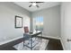Bright office features a modern desk, dark hardwood floors, neutral walls, and a patterned rug at 7819 Canyon Lake Cir, Orlando, FL 32835
