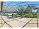 Wide angle view of the screen enclosed pool with waterfall feature at 7819 Canyon Lake Cir, Orlando, FL 32835
