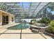 The screened-in pool features a rock waterfall and spa at 7819 Canyon Lake Cir, Orlando, FL 32835