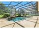 Relaxing pool area featuring a waterfall and screened enclosure at 7819 Canyon Lake Cir, Orlando, FL 32835