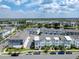 Beautiful aerial view of a community of townhomes near a tranquil lake and community green space at 8484 Sperry St, Orlando, FL 32827