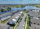 Picturesque aerial view of townhomes near a lake, showcasing community layout and waterfront proximity at 8484 Sperry St, Orlando, FL 32827