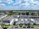 Expansive aerial view of townhomes, scenic lake and meticulously planned community at 8484 Sperry St, Orlando, FL 32827