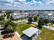 Aerial view of neighborhood streets, green space, and modern gray townhomes in a Gathering friendly community at 8484 Sperry St, Orlando, FL 32827