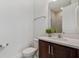 Modern half bathroom featuring wood vanity, quartz countertop, and ample space at 8484 Sperry St, Orlando, FL 32827