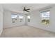 Spacious bedroom with carpet, a ceiling fan, and multiple windows at 8484 Sperry St, Orlando, FL 32827