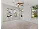 Bright, airy bedroom with plush carpet, ceiling fan, and ample natural light at 8484 Sperry St, Orlando, FL 32827