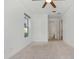 Bedroom with plush carpet, window, ceiling fan, and ensuite bathroom at 8484 Sperry St, Orlando, FL 32827