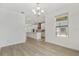 Spacious dining room with hardwood floors, modern lighting, and view into the open-concept kitchen area at 8484 Sperry St, Orlando, FL 32827