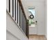 Inviting entryway featuring a modern door, staircase with black balusters and hardwood floors at 8484 Sperry St, Orlando, FL 32827