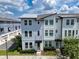 Charming two-story townhome with light blue siding, white trim, and well-maintained landscaping at 8484 Sperry St, Orlando, FL 32827
