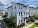 Contemporary townhome with light blue siding, multiple windows, and neat landscaping at 8484 Sperry St, Orlando, FL 32827