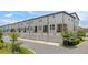 Row of townhomes with attached garages and small balconies, surrounded by mature trees at 8484 Sperry St, Orlando, FL 32827