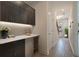 Modern hallway with custom cabinets, stylish lighting and hardwood flooring at 8484 Sperry St, Orlando, FL 32827