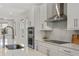 This modern kitchen features stainless steel appliances, including a range hood, and sleek countertops at 8484 Sperry St, Orlando, FL 32827