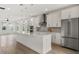 Modern kitchen with stainless steel appliances, quartz countertops, white cabinetry, and large central island at 8484 Sperry St, Orlando, FL 32827