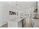 Bright, open-concept kitchen with a spacious island, modern appliances, and hardwood flooring flowing into living area at 8484 Sperry St, Orlando, FL 32827
