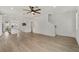 Open-concept living room showcasing beautiful hardwood flooring and a clean, modern aesthetic at 8484 Sperry St, Orlando, FL 32827