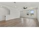 Open-concept living room with hardwood floors, staircase, and ample light at 8484 Sperry St, Orlando, FL 32827