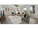 Bright living room with hardwood floors, neutral furniture, and lots of natural light at 8484 Sperry St, Orlando, FL 32827