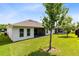 Spacious backyard featuring a well-maintained lawn and a view of the home's exterior at 977 Talon Pl, Winter Springs, FL 32708
