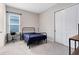 Neutral bedroom with a bed, desk by the window, and a closet with sliding doors at 977 Talon Pl, Winter Springs, FL 32708