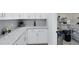 Bright butler's pantry with white cabinetry, granite countertops, and stylish decor at 977 Talon Pl, Winter Springs, FL 32708